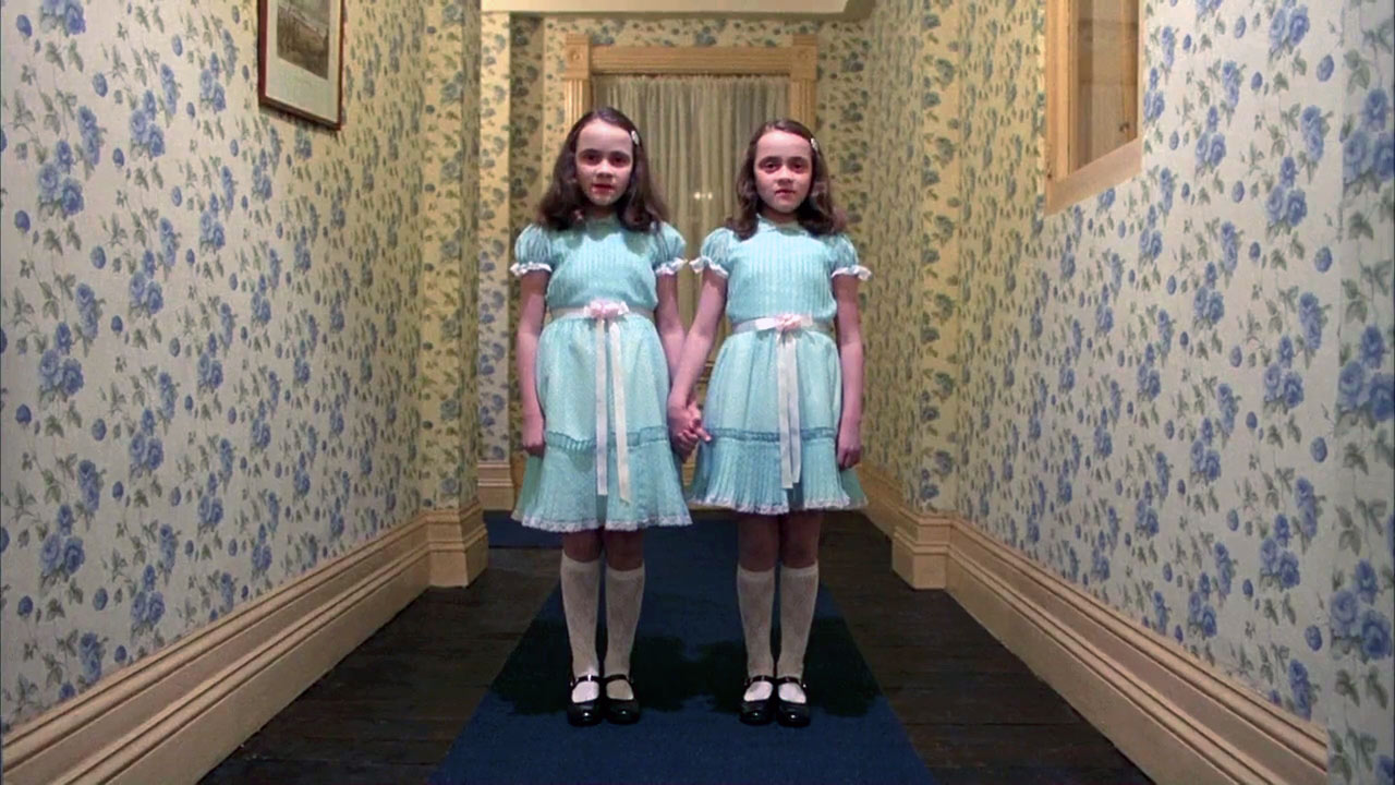 A screenshot of twin girls from the movie, The Shining.