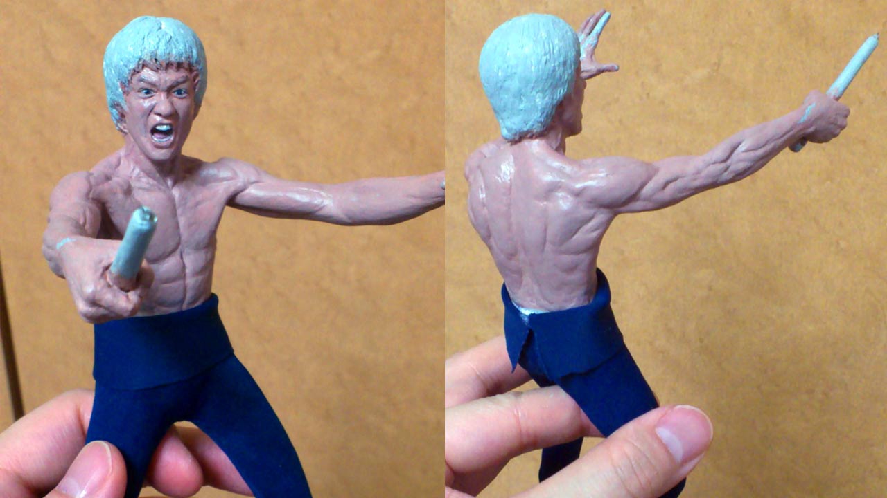 Two images side by side in a medium close up of Mister LEE fully painted with skin and facial features except the hair